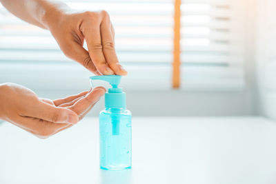 Close-up of hand holding bottle