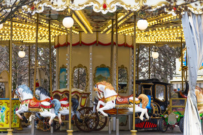 Traditional parisian merry-go-round. close up view of a carousel. illuminated horses.