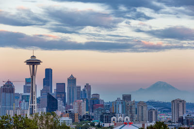 View of cityscape against cloudy sky