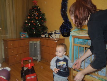 Rear view of girl and christmas tree