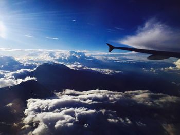 Aerial view of cloudscape over airplane wing