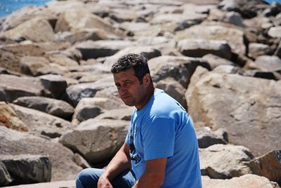 Side view of man standing on rock