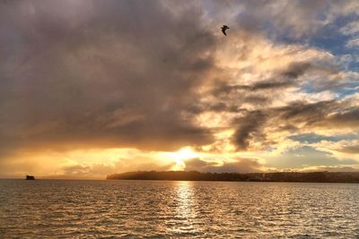Scenic view of sea against dramatic sky
