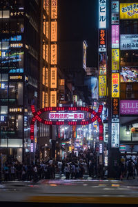 Illuminated city street and buildings at night