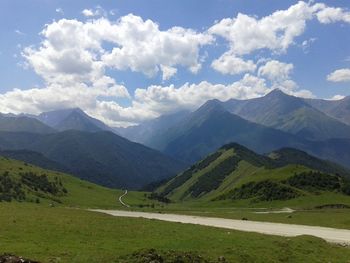 Scenic view of mountains against cloudy sky