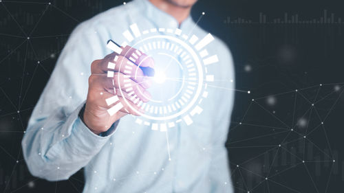 Midsection of man holding camera