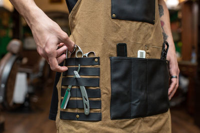 Midsection of man standing in workshop