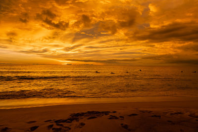 Scenic view of beach against sky during sunset