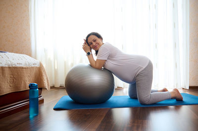 Side view of woman exercising in gym