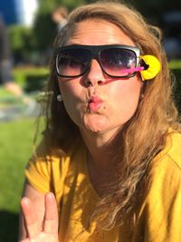 Portrait of woman making a face while gesturing peace sign