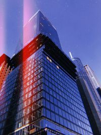 Low angle view of modern building against clear blue sky