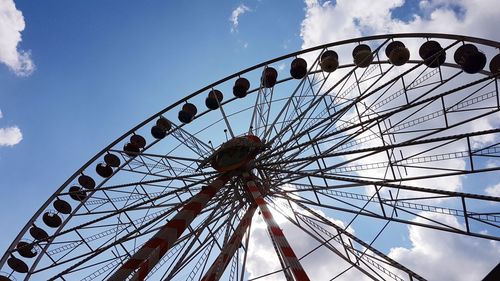 Low angle view of ferris wheel against sky