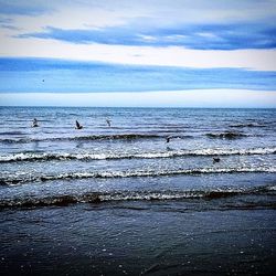 Scenic view of sea against cloudy sky