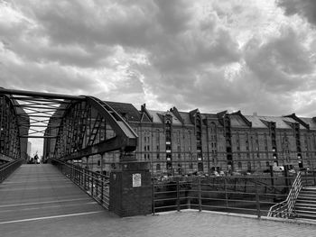 Low angle view of buildings against cloudy sky