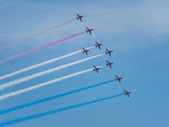 Low angle view of airshow against sky