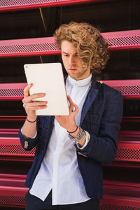 Close-up of man using digital tablet indoors