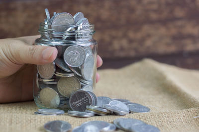 Close-up of hand holding glass jar