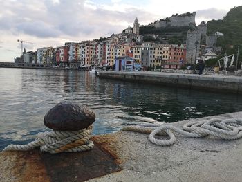 Scenic view of river by city against sky