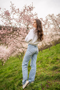 Rear view of woman standing on field