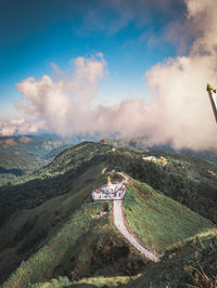 Aerial view of mountain range against cloudy sky
