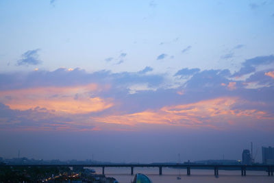 View of bridge over river against cloudy sky