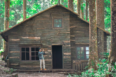 Rear view of man standing outside house