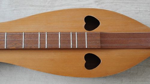 Close-up of guitar on table