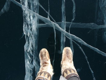 Low section of man standing on ice