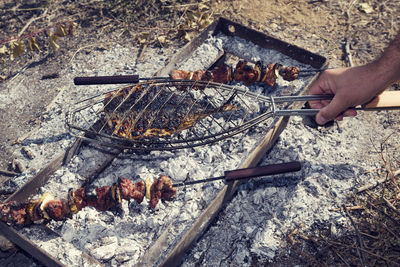 Low angle view of people on barbecue grill