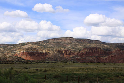 Countryside landscape against cloudy sky