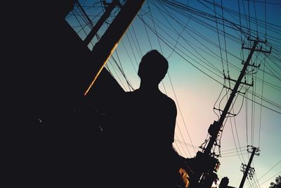 Low angle view of silhouette man against sky