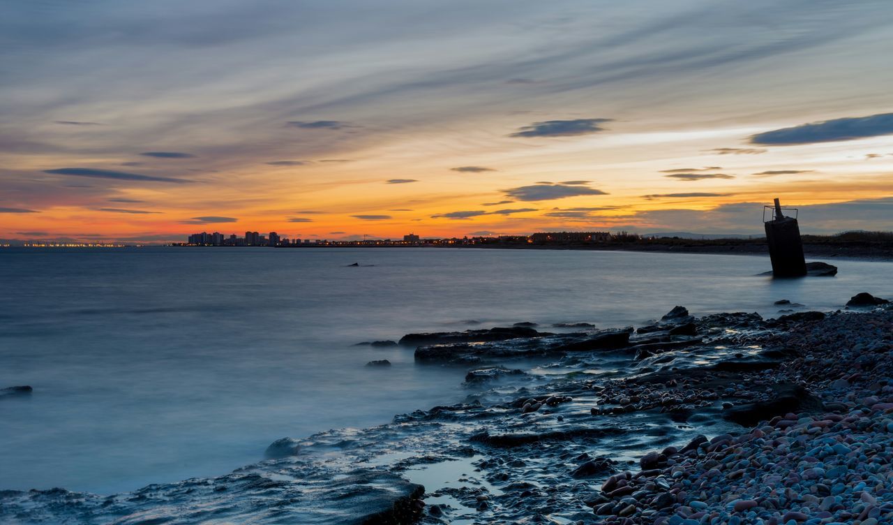 sunset, sea, water, scenics, sky, beauty in nature, tranquil scene, orange color, tranquility, rock - object, nature, horizon over water, idyllic, beach, cloud - sky, silhouette, shore, dusk, outdoors, non-urban scene