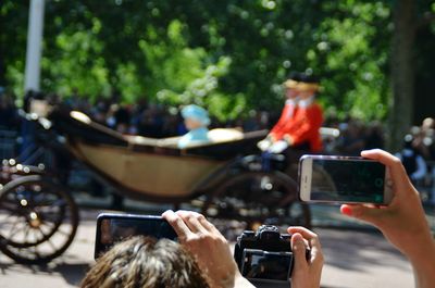 Man photographing with mobile phone in bus