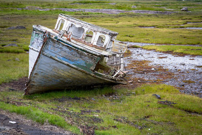 Abandoned boat on land