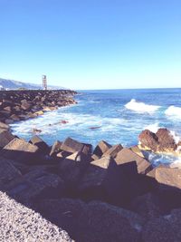 Scenic view of sea against clear blue sky