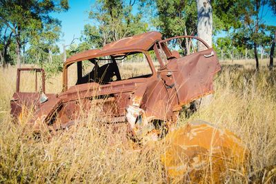 Abandoned car on field