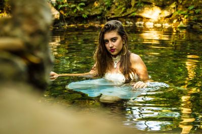 Young woman swimming in lake