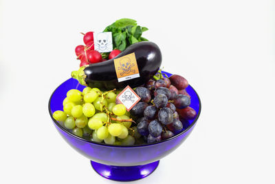 High angle view of fruits in bowl against white background