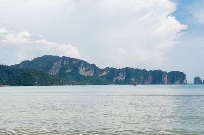 Scenic view of sea and mountains against sky