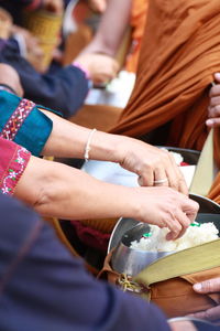 Midsection of woman holding food in container