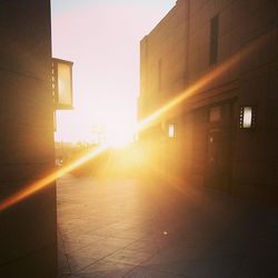 Sun shining through buildings in city