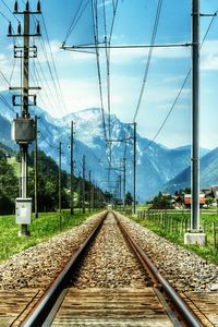 Railroad tracks against cloudy sky