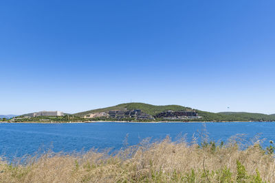 Scenic view of sea against clear blue sky