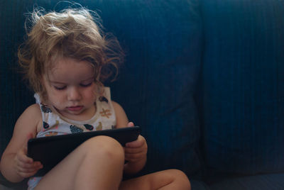 Close-up of girl using digital tablet at home