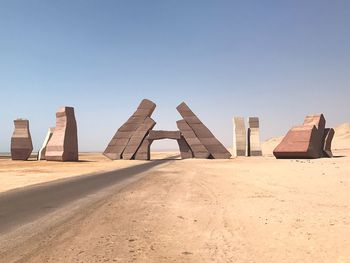 Sand dune in desert against clear sky