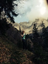 Portrait of a young woman standing on landscape