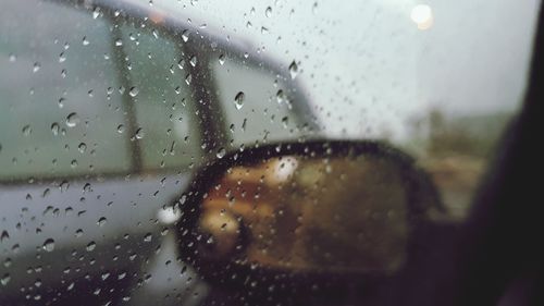 Close-up of wet glass window in rainy season