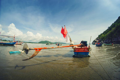 Boats moored on sea against sky