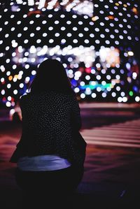 Rear view of person with illuminated christmas lights