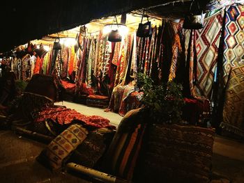 Illuminated lanterns hanging at market stall